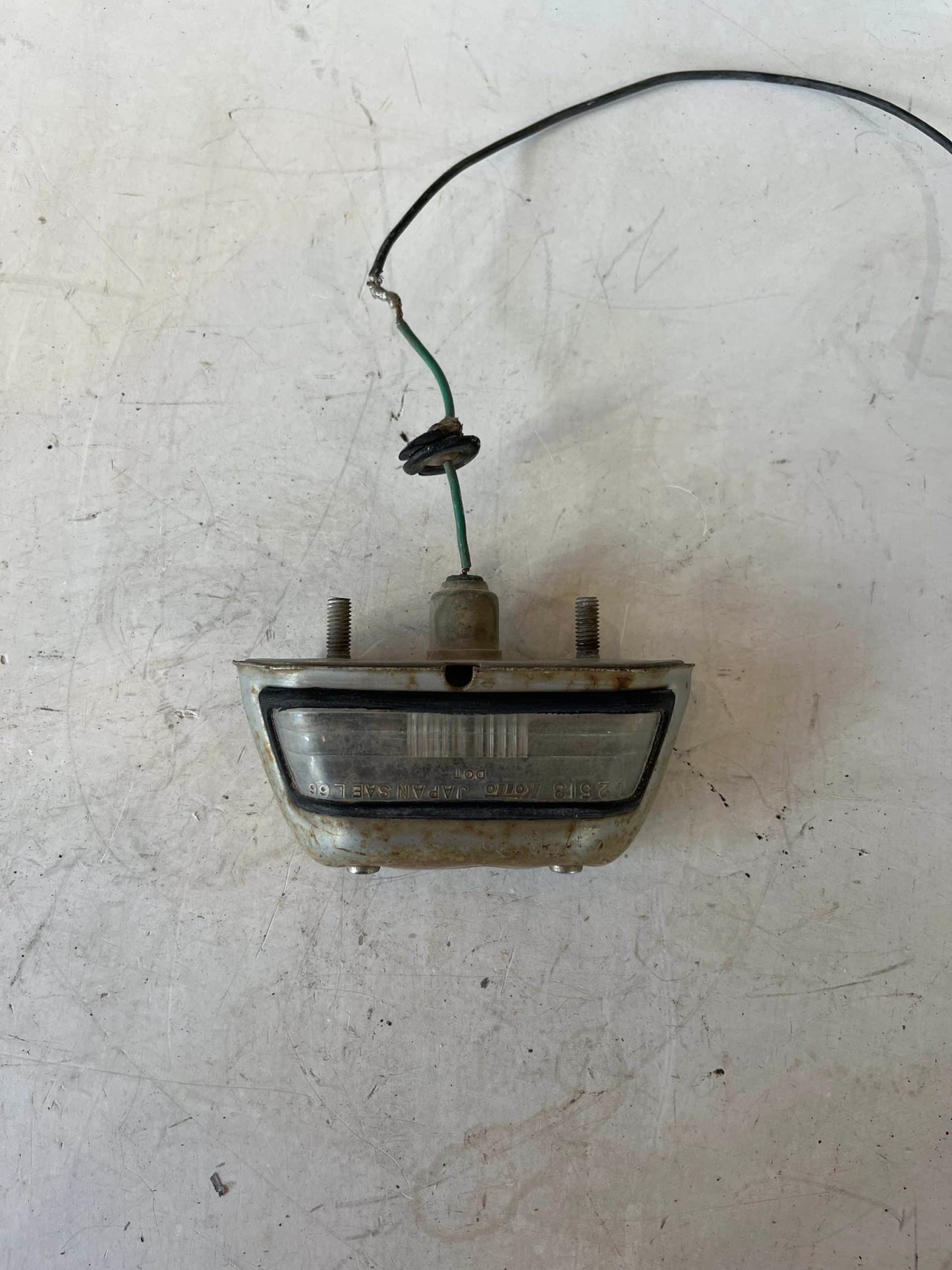 Used Early License Plate Light Assembly